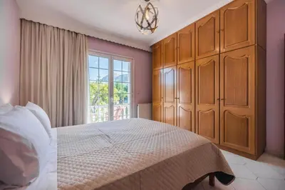a bedroom with a large bed and a window at Casa Garden in Archangelos