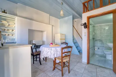 a kitchen and dining room with a table and chairs at Afaia Apartments in Symi