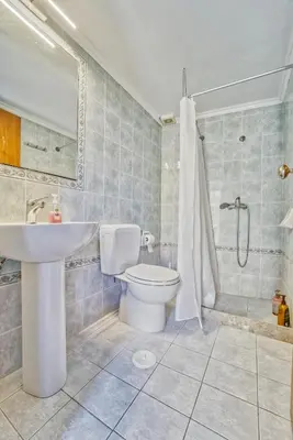 a bathroom with a toilet and a sink and a shower at Afaia Apartments in Symi