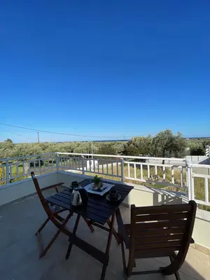 a blue table and two chairs on a balcony at Marilia relaxing home, Afantou in Afantou