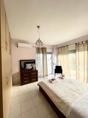 a large bedroom with a bed and a television at Marilia relaxing home, Afantou in Afantou