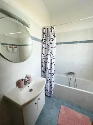 a bathroom with a sink and a shower curtain at Marilia relaxing home, Afantou in Afantou