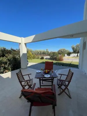 a patio with a table and chairs on a patio at Marilia relaxing home, Afantou in Afantou