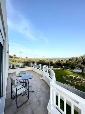 a patio with a table and chairs on a balcony at Marilia relaxing home, Afantou in Afantou