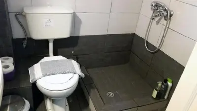 a bathroom with a toilet and a shower at Medieval Rose Guest House in Rhodes Town