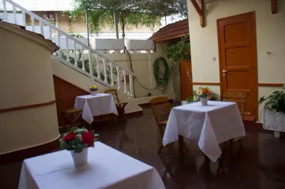 two tables with flowers on them in a room at Medieval Rose Guest House in Rhodes Town