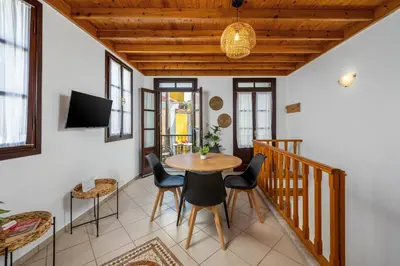a dining room with a table and chairs at Ilioni Apartment in Symi