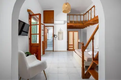 a hallway with a staircase and a living room at Lito Studio in Symi