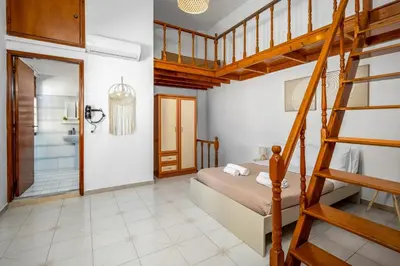 a bedroom with a bunk bed and a ladder at Lito Studio in Symi
