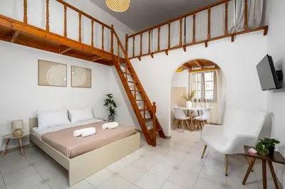a bedroom with a loft bed and a staircase at Lito Studio in Symi