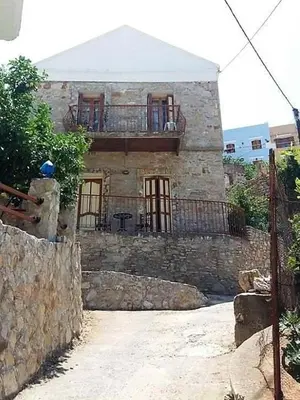 a stone house with a balcony on top of it at 