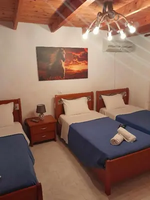 a bedroom with two beds and a painting on the wall at 