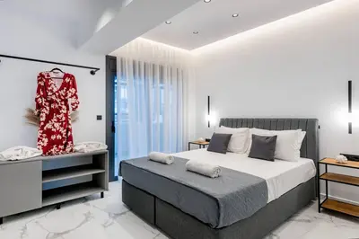 a bedroom with a bed and a dress on a rack at Rhodes Center Luxury Apartments #2 in Rhodes Town