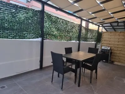 a wooden table and chairs on a patio at Rhodes Center Luxury Apartments #2 in Rhodes Town