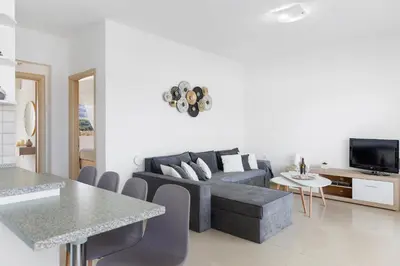 a living room with a couch and a table at Grande View Haraki in Haraki