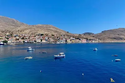 a group of boats in a large body of water at Waterfront Family Villa in Halki