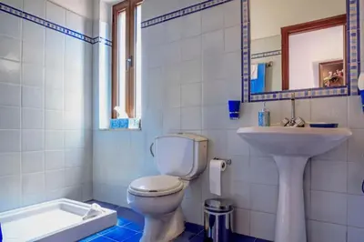 a bathroom with a toilet and a sink at Waterfront Family Villa in Halki