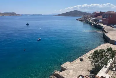a large body of water with a boat in it at Waterfront Family Villa in Halki