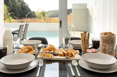 a table with a plate of food on it at M&B Luxury Villa in Haraki