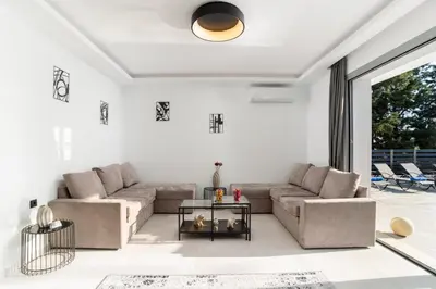 a living room with a couch and a table at M&B Luxury Villa in Haraki