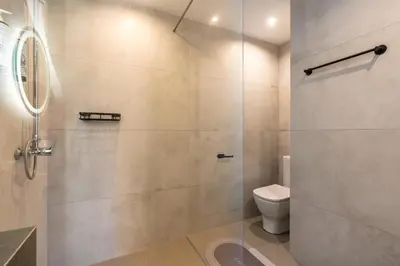 a bathroom with a shower stall and a toilet at M&B Luxury Villa in Haraki
