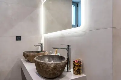 a bathroom with two sinks on a counter at M&B Luxury Villa in Haraki