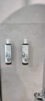 two bottles ofodorizers on a wall in a bathroom at M&B Luxury Villa in Haraki