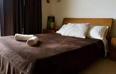 a bedroom with a bed with two towels on it at Villa Nostra- Cars Included in Soroni
