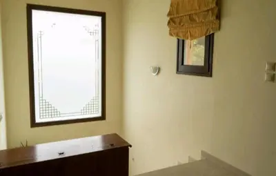 a room with a window and a wooden table at Villa Nostra- Cars Included in Soroni