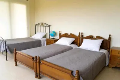 a bedroom with two twin beds and a window at Villa Nostra- Cars Included in Soroni