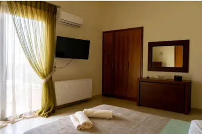 a bedroom with a bed with a mirror and a window at Villa Nostra- Cars Included in Soroni