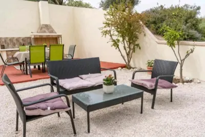 a group of chairs and a table on a patio at Villa Nostra- Cars Included in Soroni