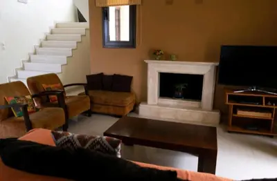 a living room with a fireplace and a tv at Villa Nostra- Cars Included in Soroni