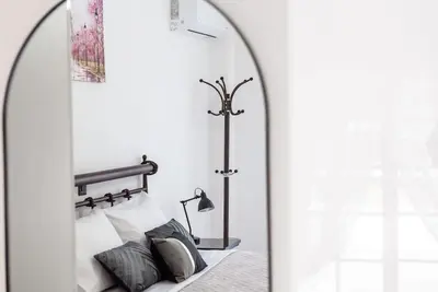a room with a bed with a mirror and a lamp at Katris Luxury Homes #1 in Triánta