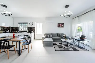 a living room with a couch and a table at Katris Luxury Homes #1 in Triánta