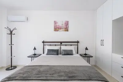 a bedroom with a large bed with two tables at Katris Luxury Homes #1 in Triánta