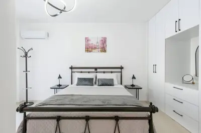 a bedroom with a bed and two night stands at Katris Luxury Homes #1 in Triánta