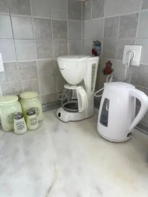 a kitchen counter with a coffee maker and a toaster at The Sunlit Retreat in Kremasti