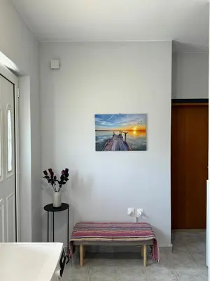 a bench in a room with a picture on the wall at The Sunlit Retreat in Kremasti