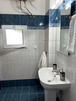 a bathroom with a sink and a mirror at The Sunlit Retreat in Kremasti