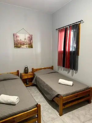 a bedroom with two beds and a window at The Sunlit Retreat in Kremasti