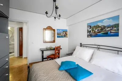 a bedroom with a bed with a desk and a chair at Anerades city center apartment in Rhodes Town