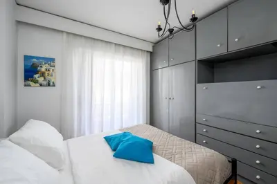 a bedroom with a bed with a blue pillow on it at Anerades city center apartment in Rhodes Town