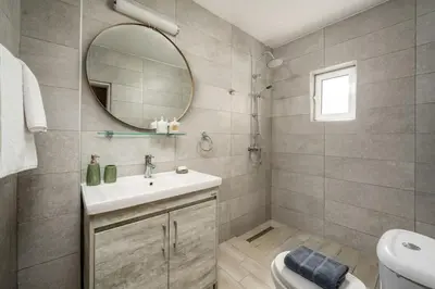 a bathroom with a sink and a mirror and a toilet at Anerades city center apartment in Rhodes Town