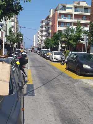 a street with cars parked on the side of the road at Anerades city center apartment in Rhodes Town