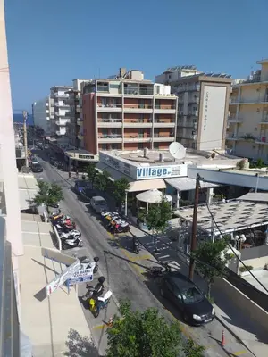 a city street with cars parked in front of a building at Anerades city center apartment in Rhodes Town