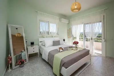 a bedroom with a bed with a dog sitting on it at Sunset villa Theologos in Theologos
