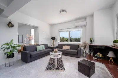 a living room with two couches and a table at Sunset villa Theologos in Theologos