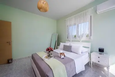 a bedroom with a bed with a teddy bear on it at Sunset villa Theologos in Theologos