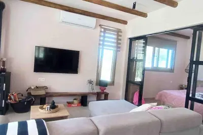 a living room with a couch and a flat screen tv at Imagio 22 in Sálakos